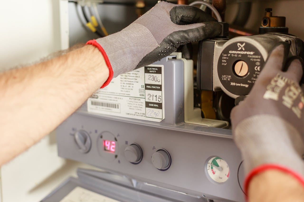 technician fixing a boiler